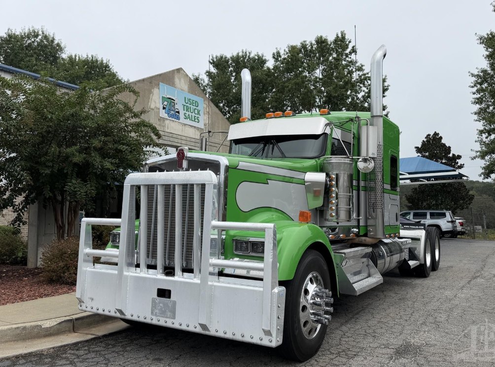 Green and white sleeper semi truck at 7E Sales